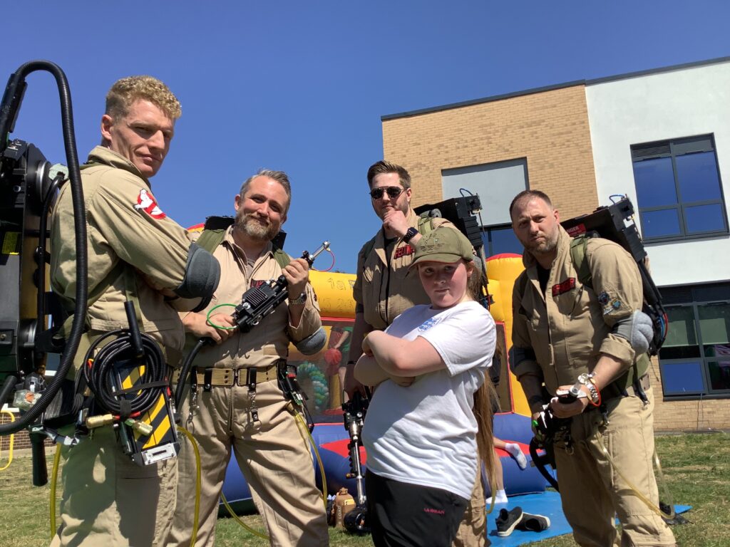Pupil poses with the Ghostbusters
