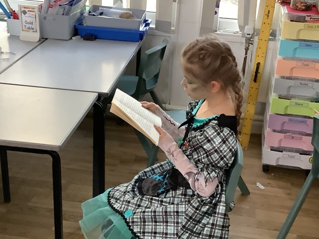 St Pauls pupil reading in fancy dress
