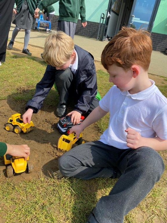 Pupils play with donated diggers and trucks