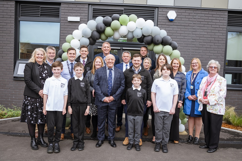 LCC, CIT, DfE and pupils stand together under a balloon arch