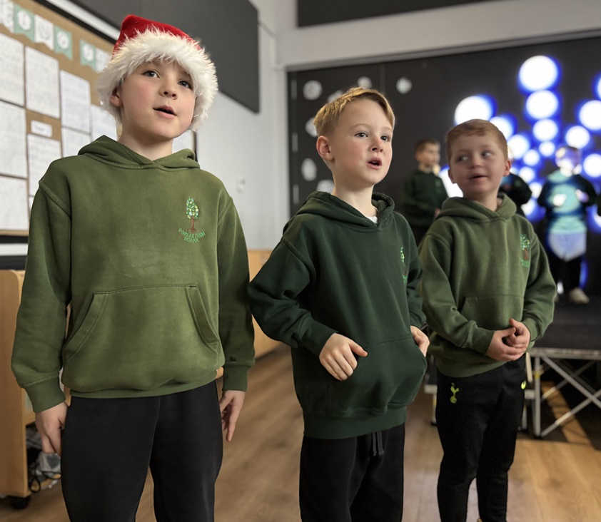 Three boys singing from Year 3