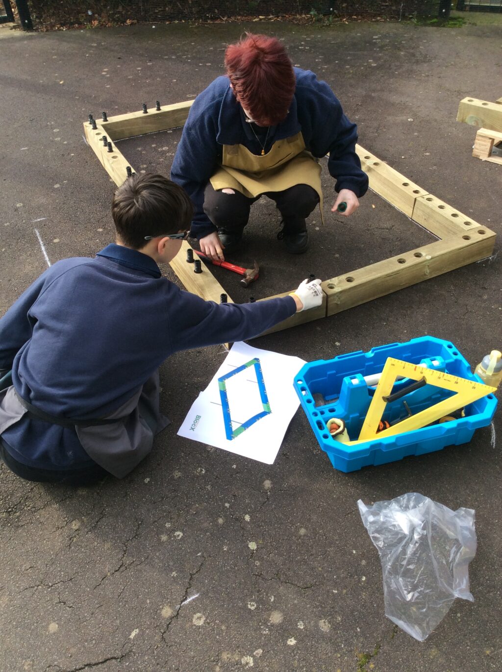 pupils get busy constructing wooden raised planter