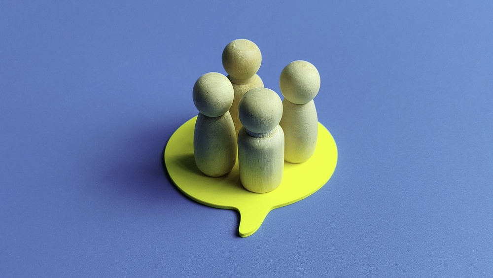 wooden figures inside a comment box